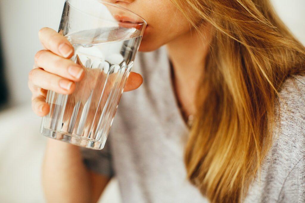 A woman drinking softened water from a glass